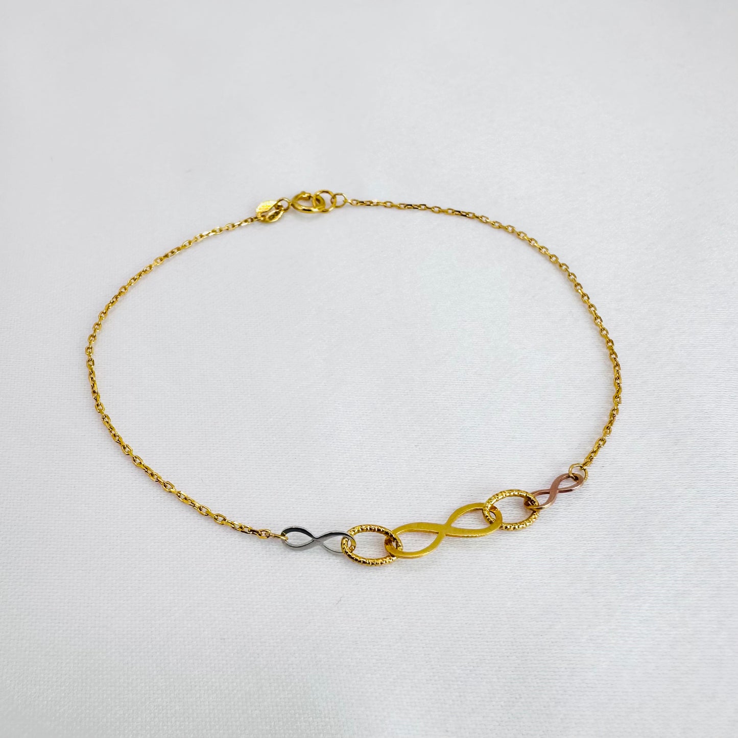 22k solid gold infinity bracelet with tricolour charms