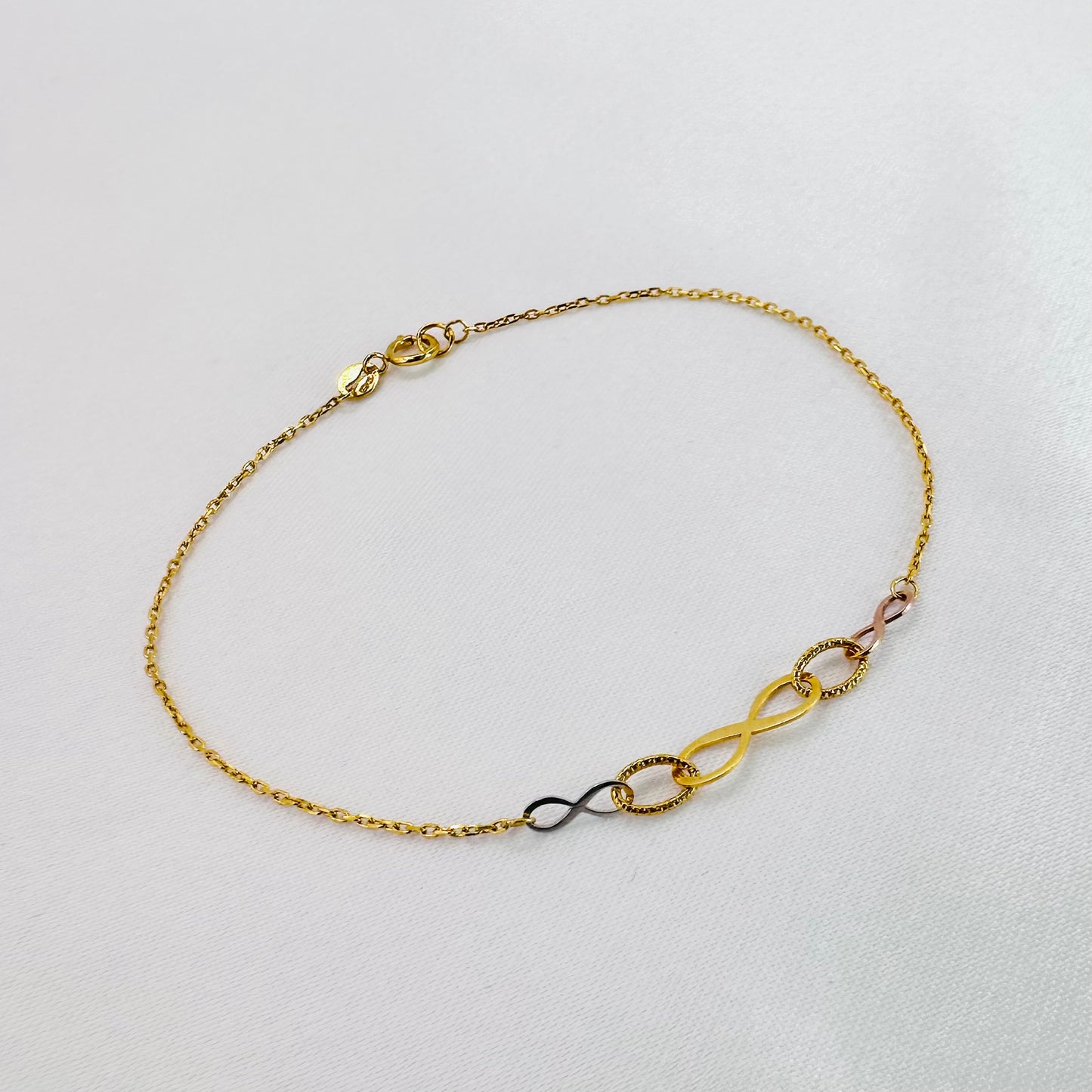 22k solid gold infinity bracelet with tricolour charms