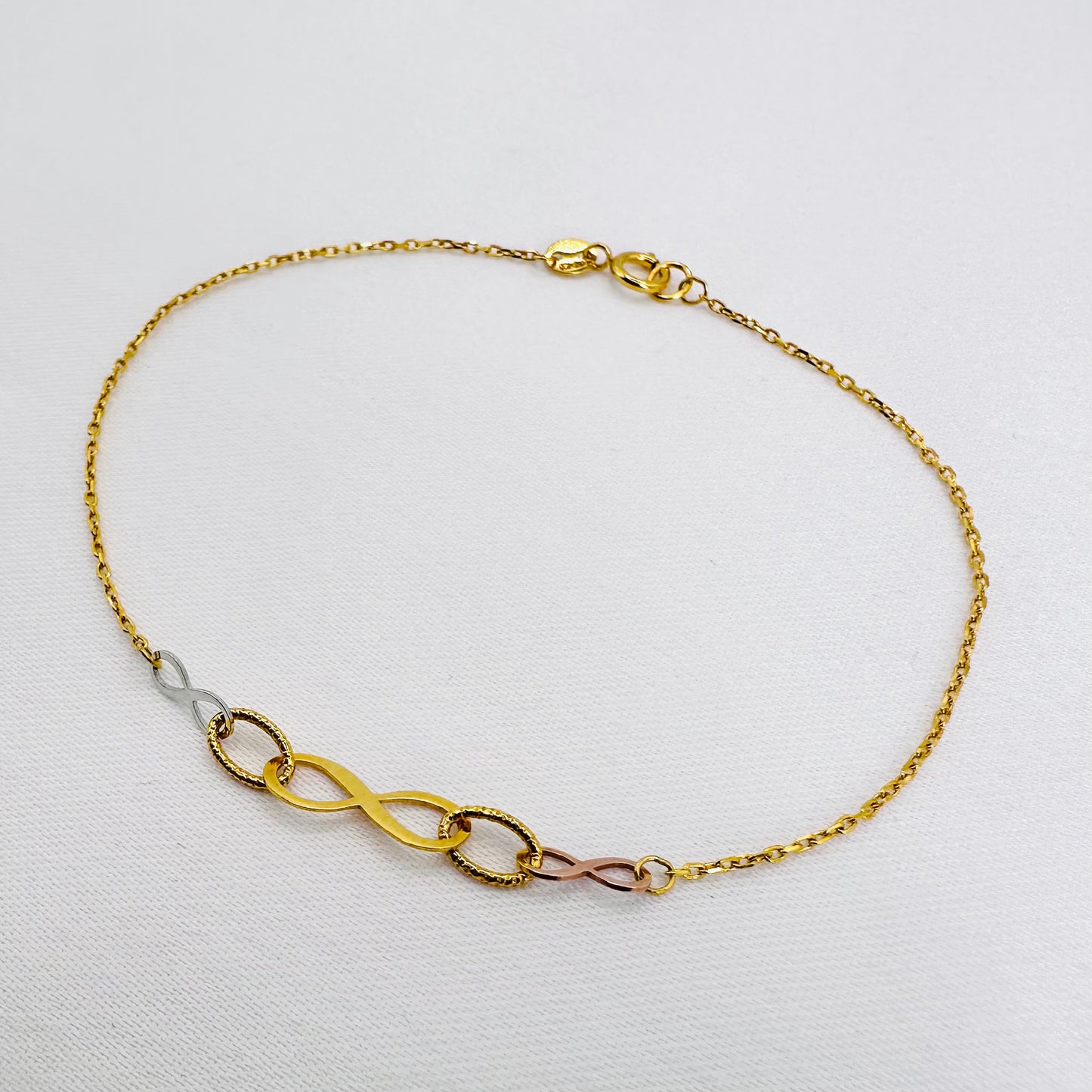 22k solid gold infinity bracelet with tricolour charms